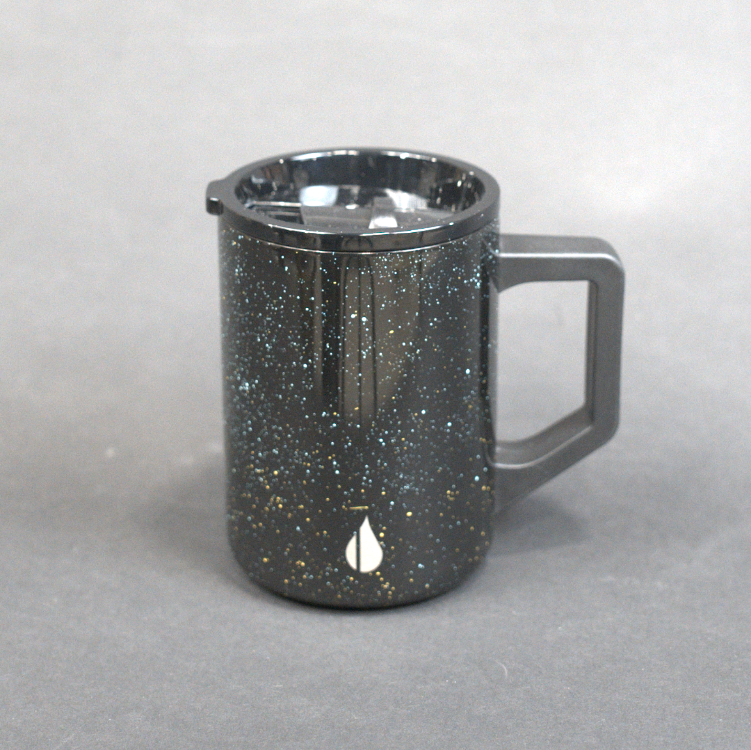 Black speckled mug on a gray background