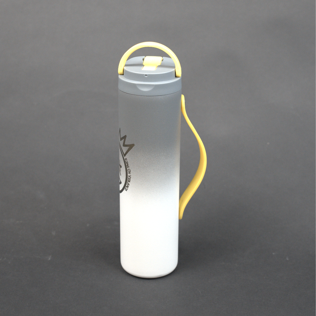 Clear cylindrical container with yellow handle on a gray background