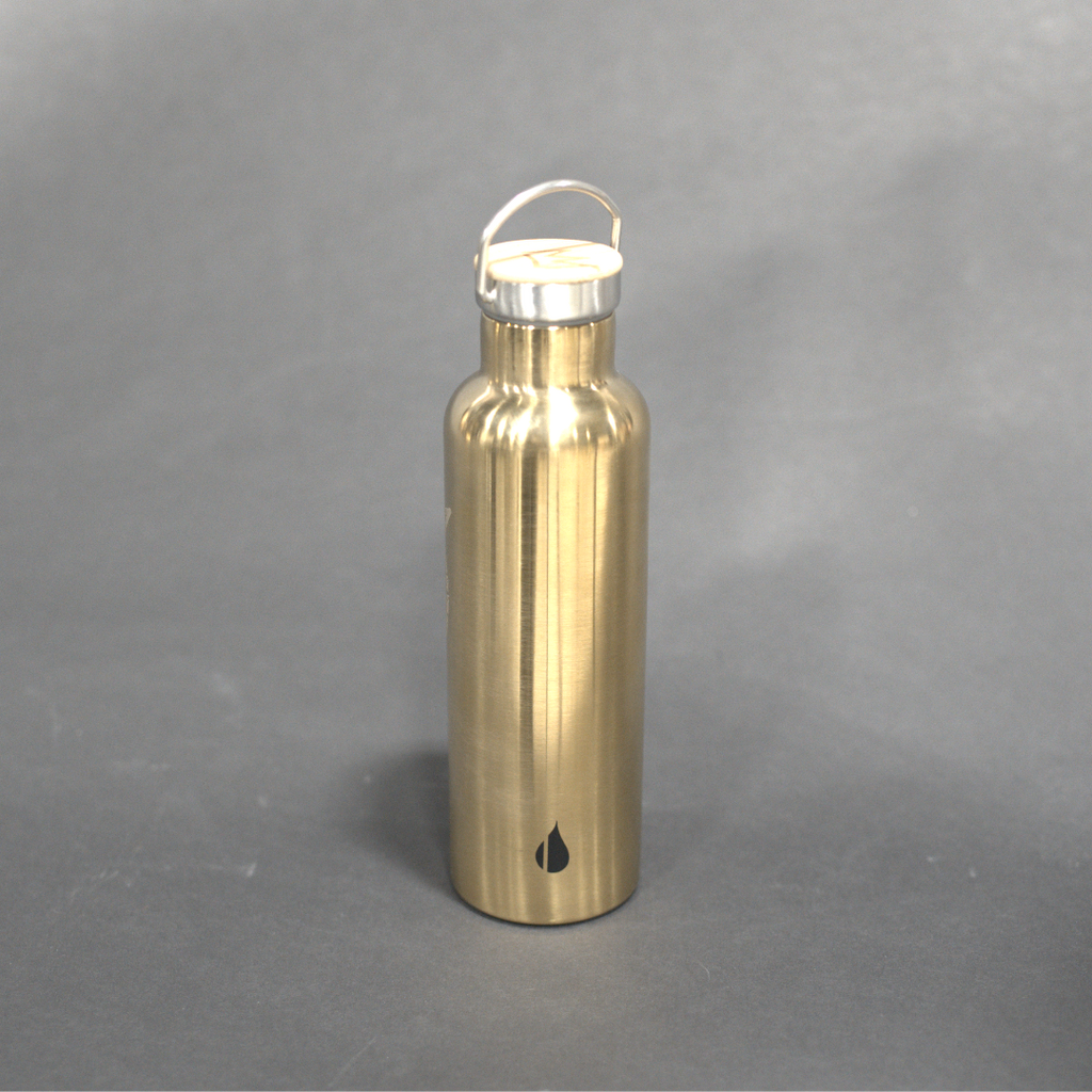 Gold water bottle with a white cap on a gray background