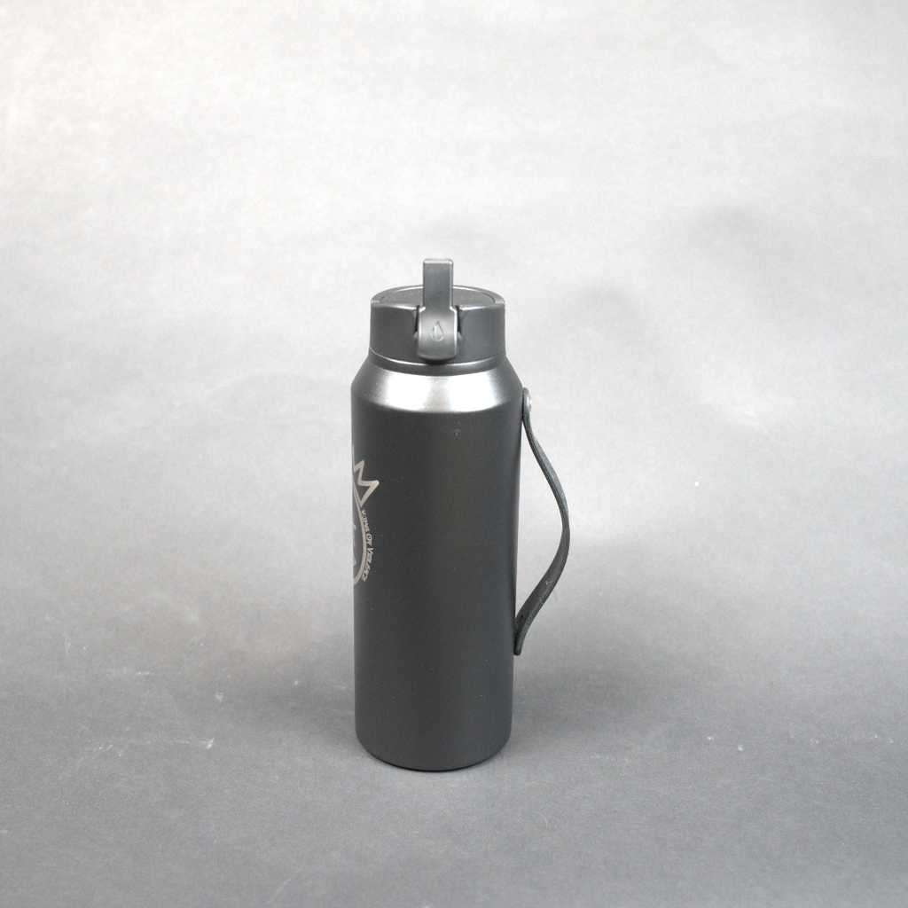 Black insulated bottle with silver cap on a gray background